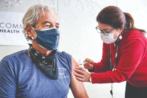 Virus dampens holidays worldwide as vaccinations gather speed