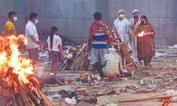 Grief-stricken families wait in   line to cremate their loved ones Grief-stricken families wait in   line to cremate their loved ones