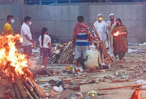 Grief-stricken families wait in   line to cremate their loved ones