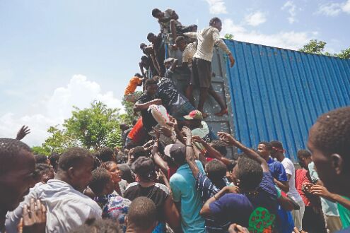 Haitian quake victims rush aid sites, take food and supplies Haitian quake victims rush aid sites, take food and supplies