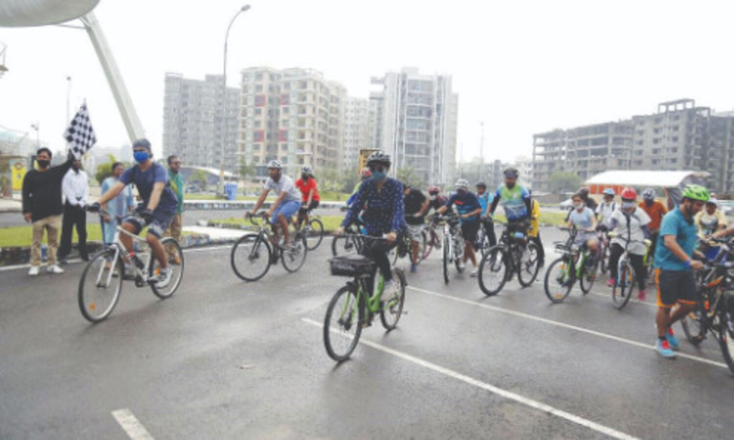 Cyclists ride through New Town to visit pandals