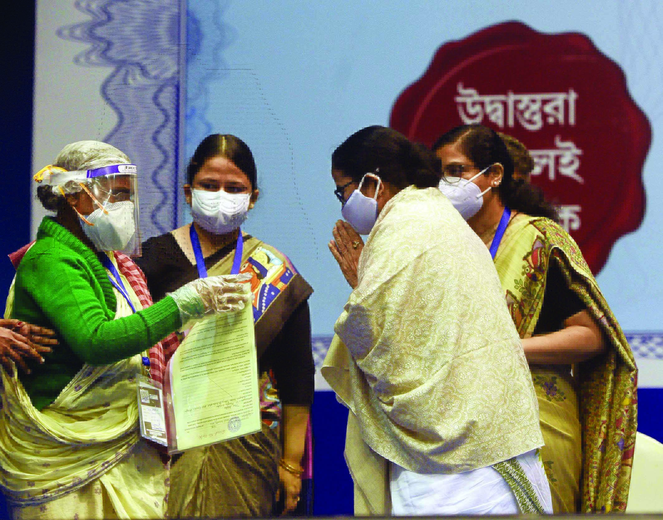 Mamata hands over more than 2K freehold title deeds Mamata hands over more than 2K freehold title deeds