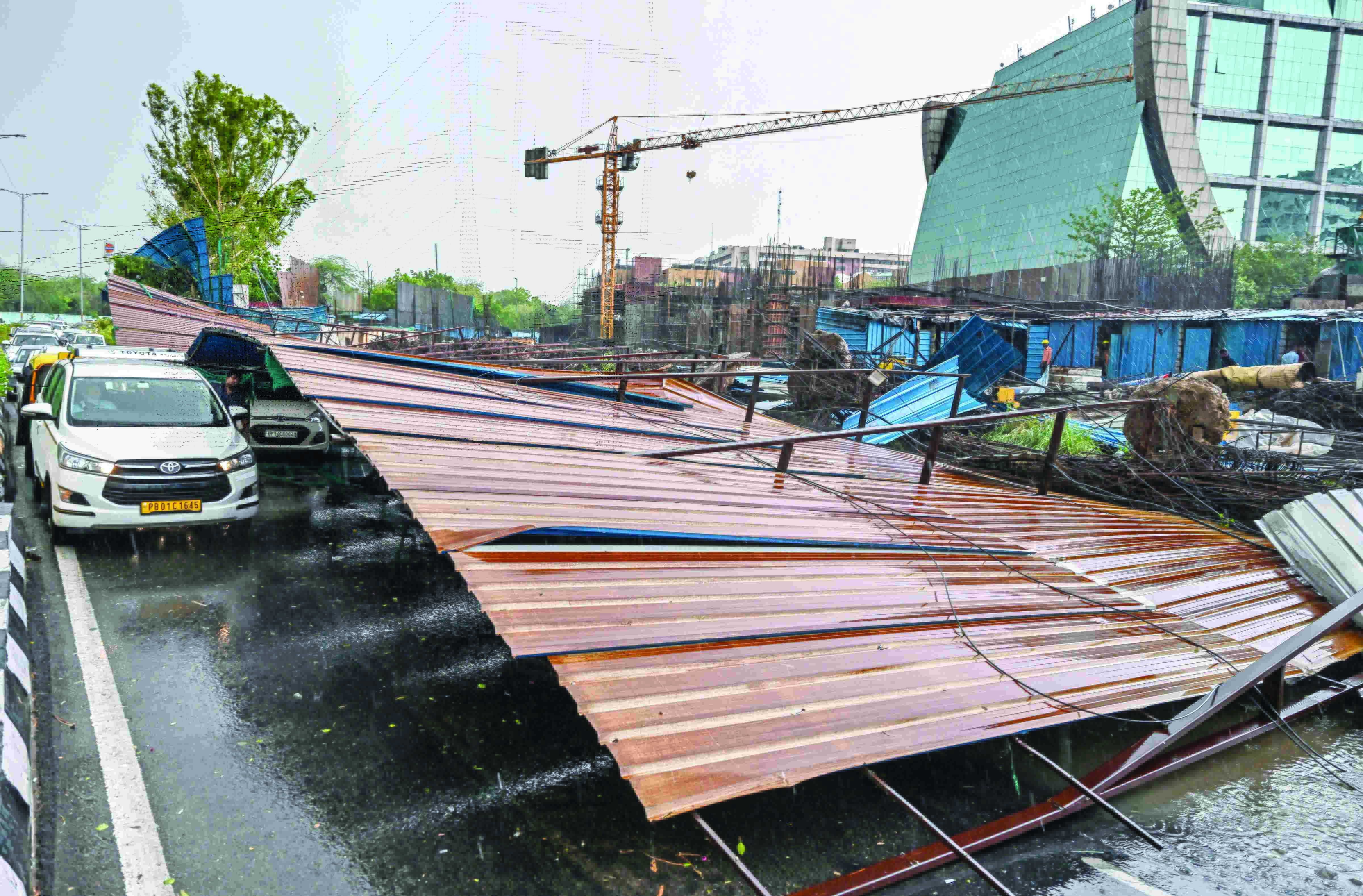 Two dead; trees uprooted, buildings damaged as heavy rain & winds wreak havoc in Delhi Two dead; trees uprooted, buildings damaged as heavy rain & winds wreak havoc in Delhi