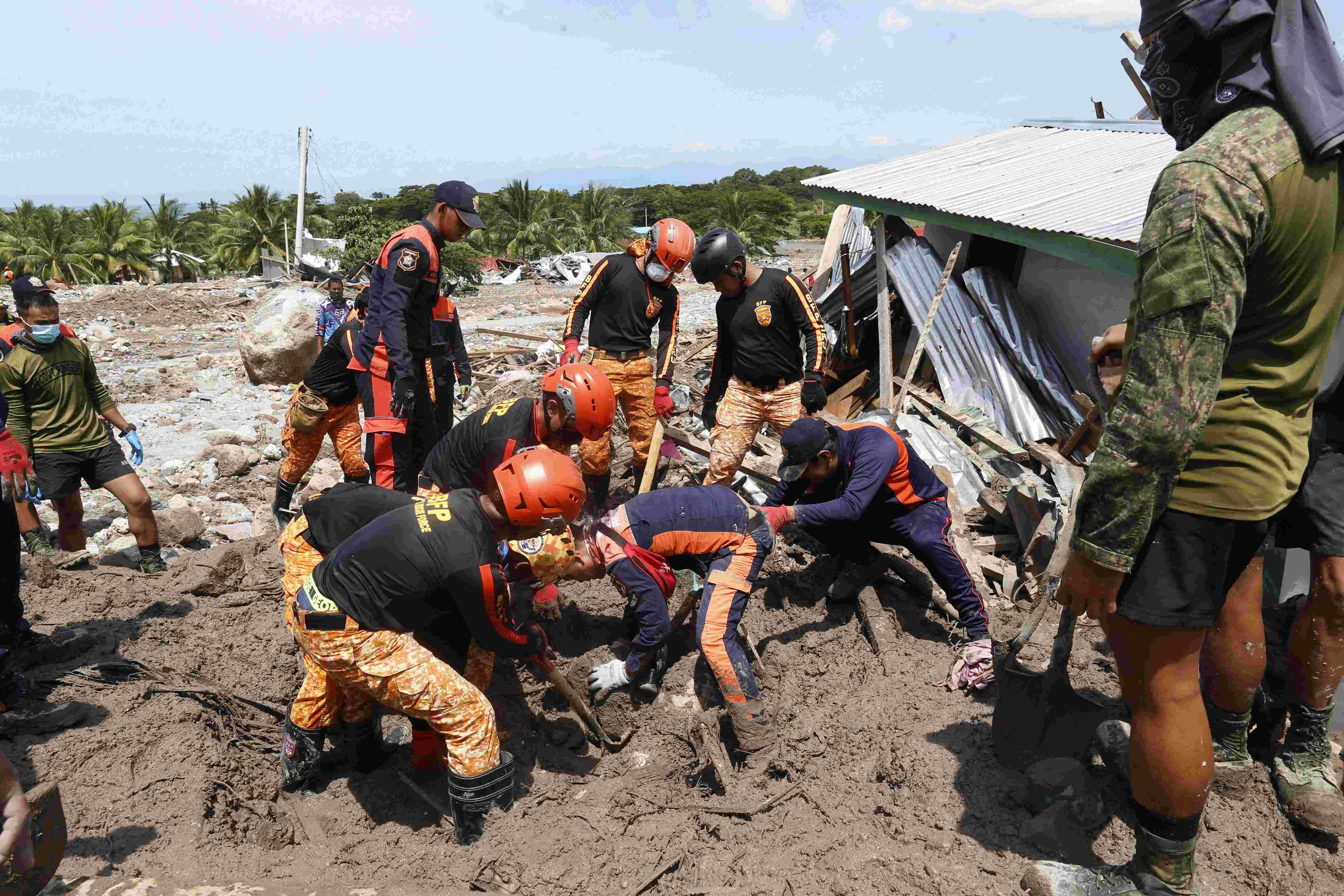 Nearly 100 dead, dozens missing in storm-ravaged Philippines