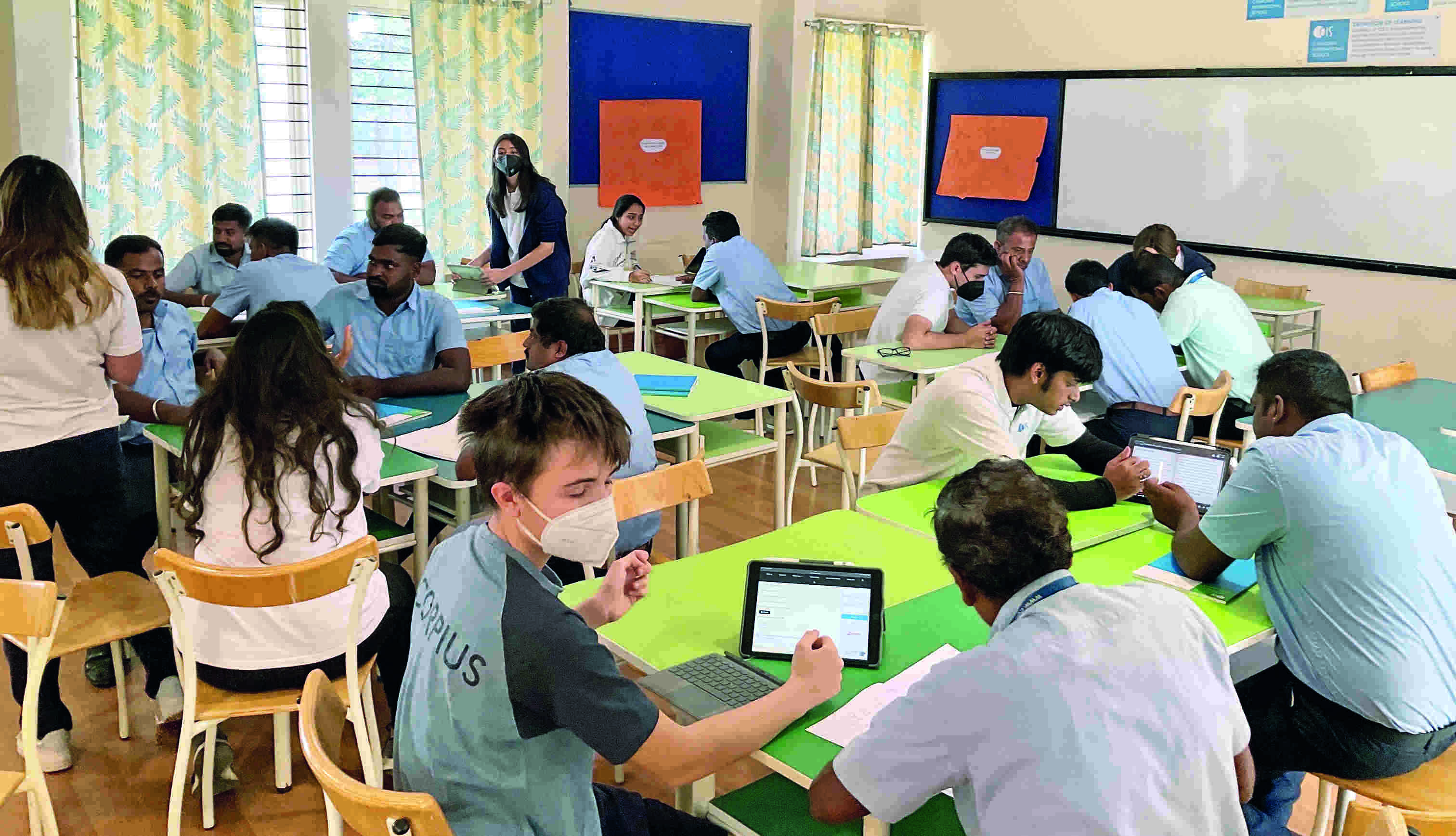 Students teach English to school housekeeping staff