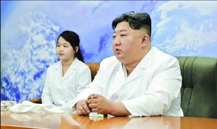 North Korea shows Kim Jong Un examining a spy satellite