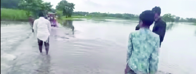 Thousands in a spot with river water flowing over bridge in Islampur
