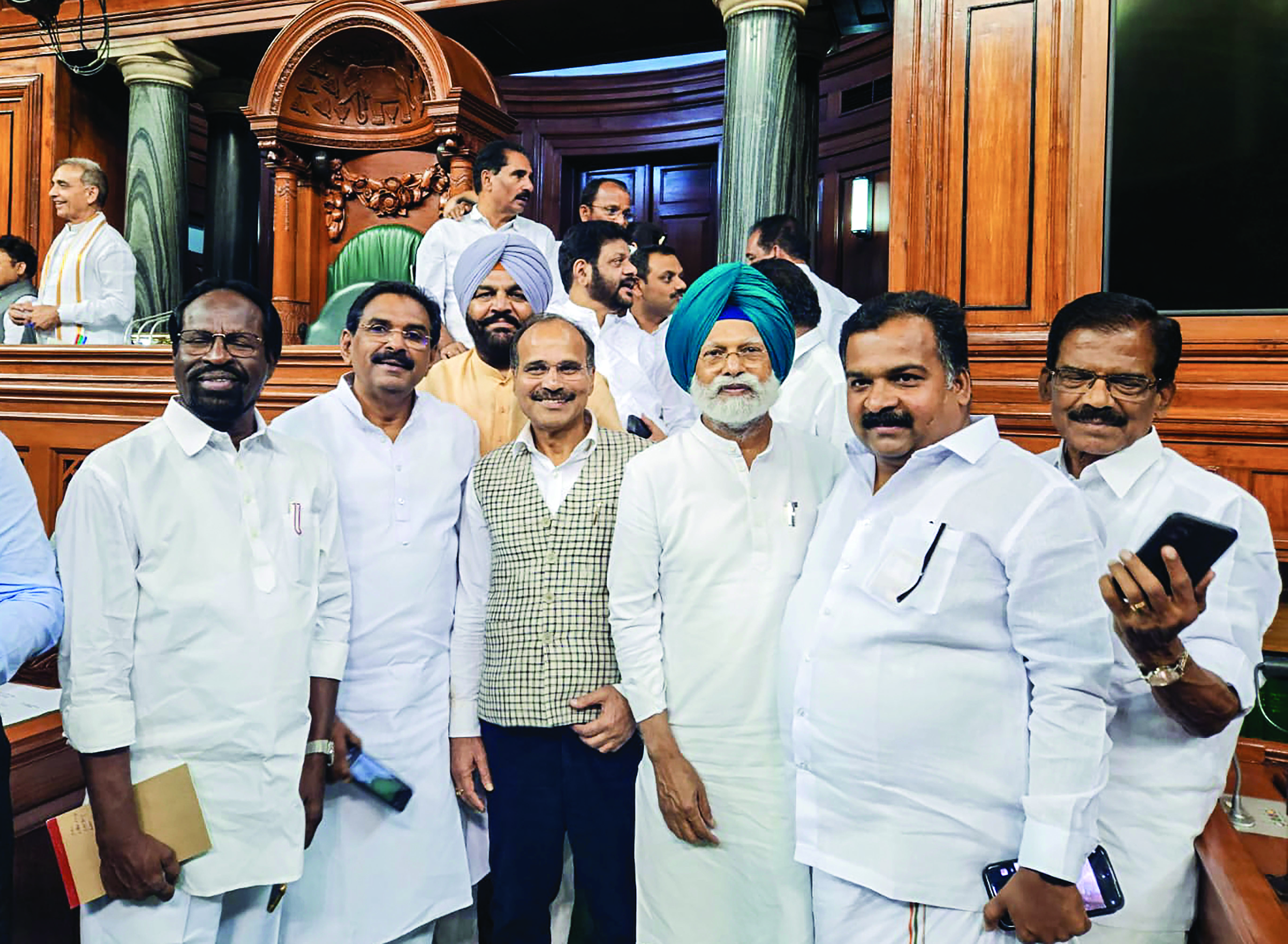 Manmohan Singh on wheelchair, BRS posters for women reservation