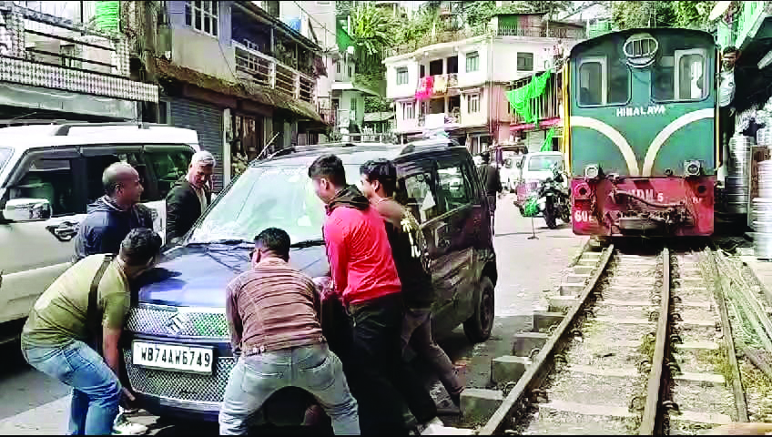 Train stalled by a parked car in Darjeeling