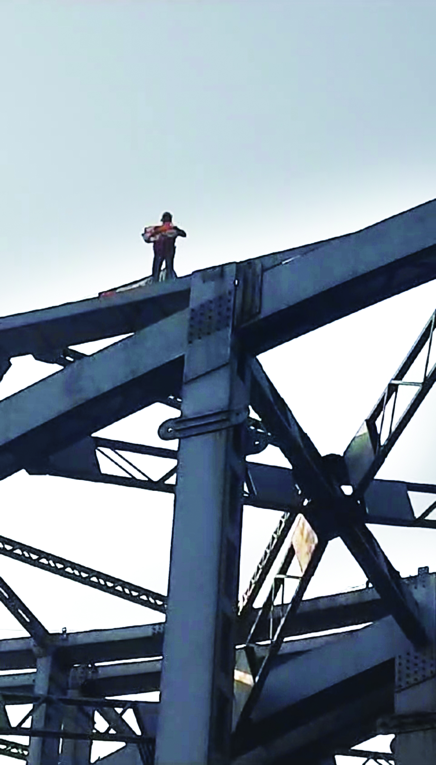 Man climbs up iron structure at Maa Flyover Man climbs up iron structure at Maa Flyover