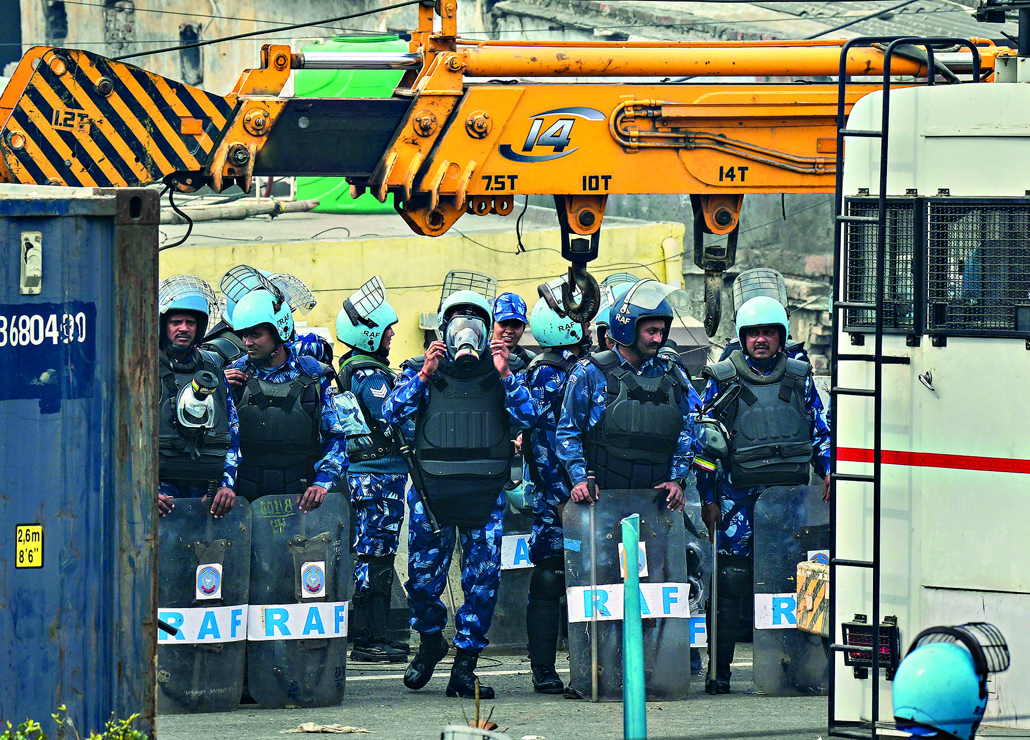 Metal, concrete barricades and cops wait for farmers