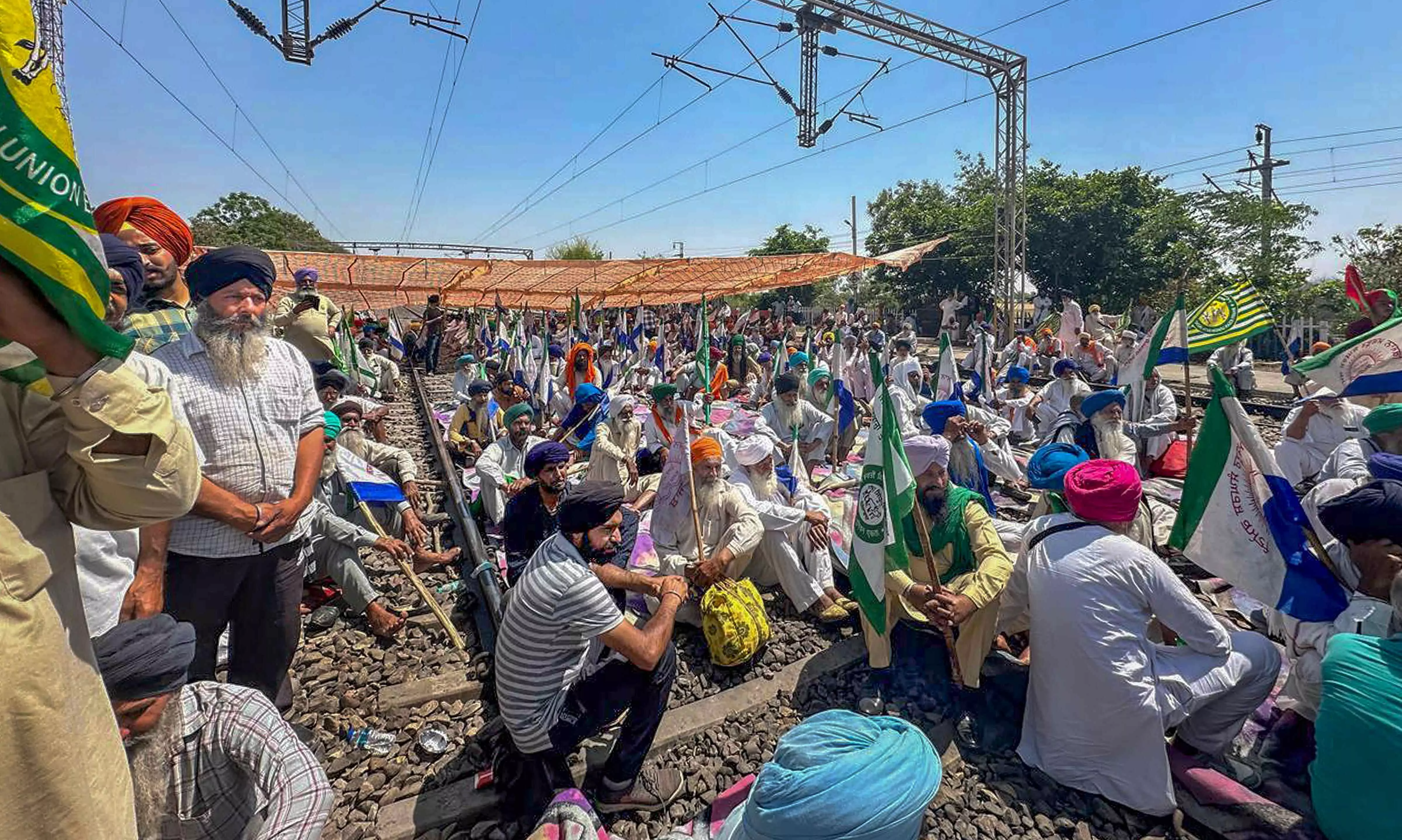 Several trains affected as farmers squat on track demanding release of fellow protesters