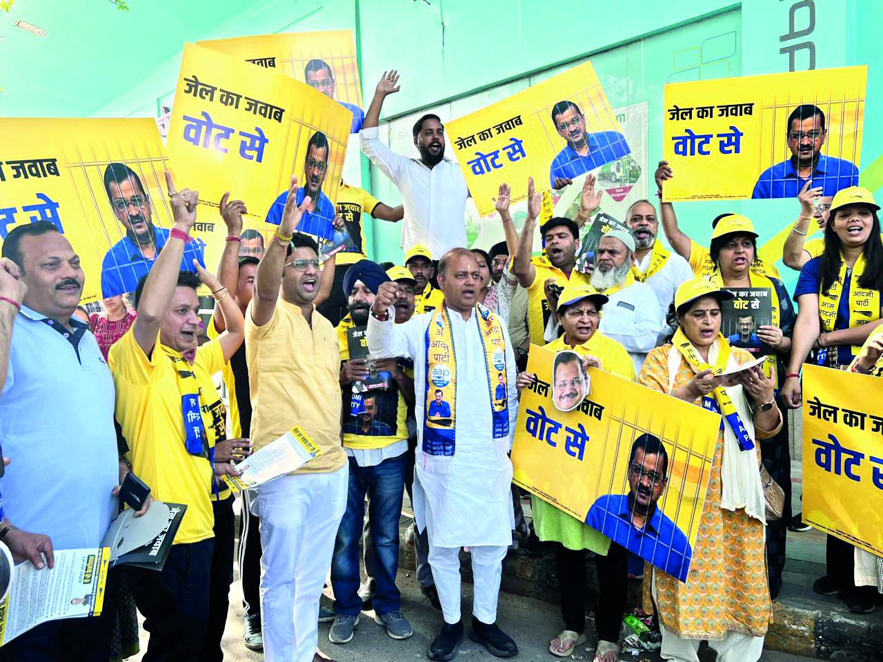 AAP members distribute pamphlets, appeal people to answer arrest of Kejriwal with votes AAP members distribute pamphlets, appeal people to answer arrest of Kejriwal with votes