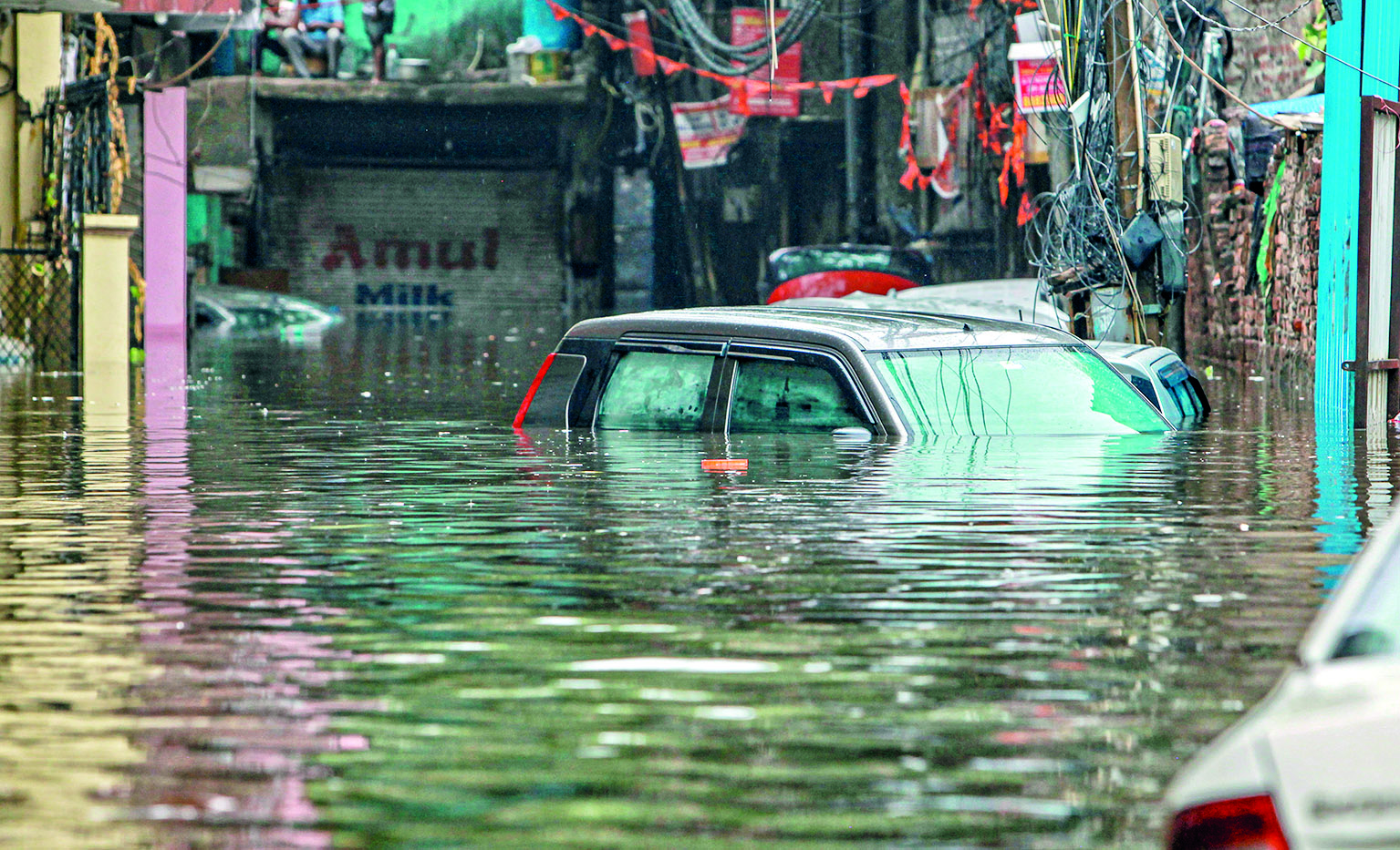 Cars afloat, roads jammed as heavy rain submerges city