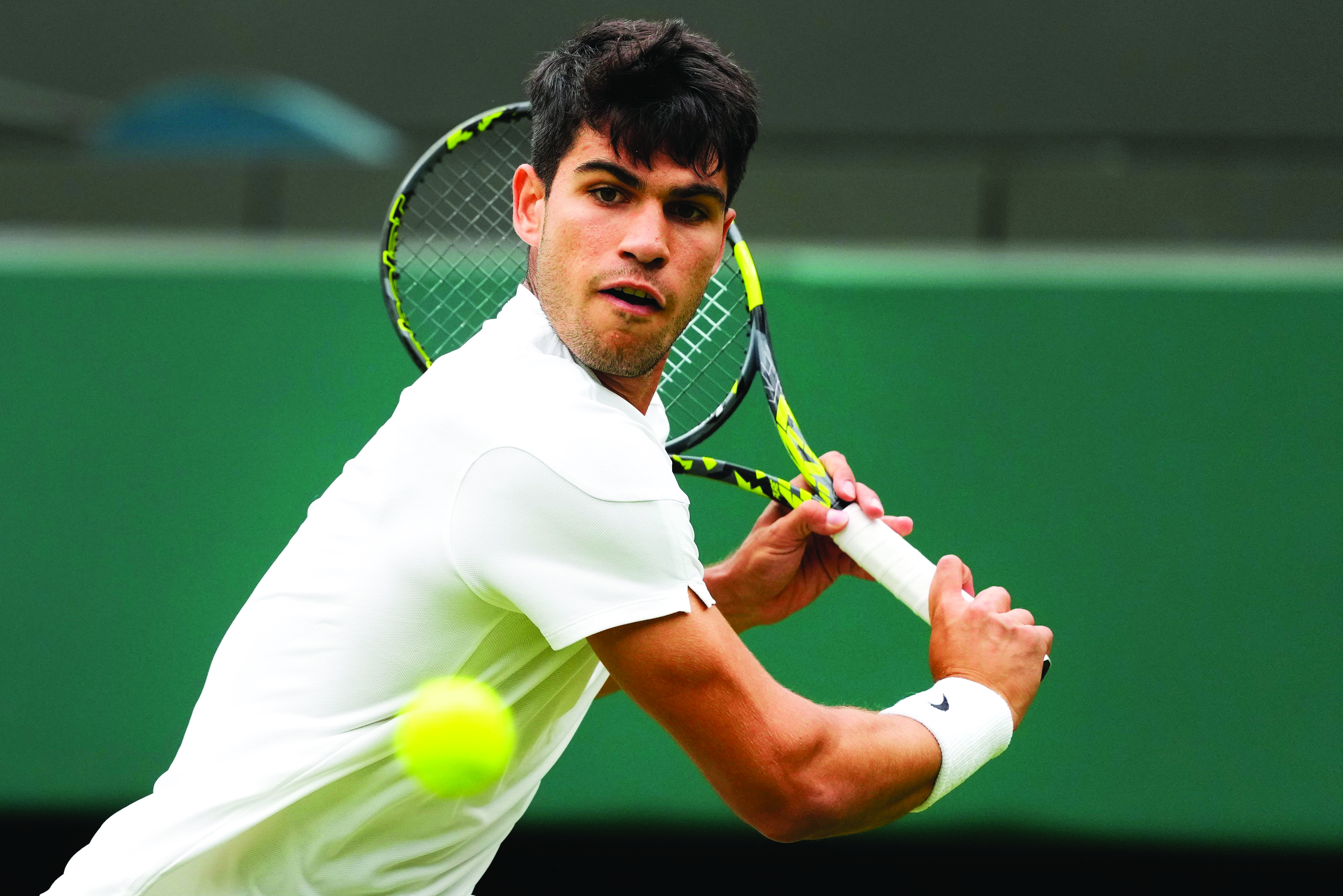 Alcaraz holds off Humbert to reach Wimbledon quarter-finals