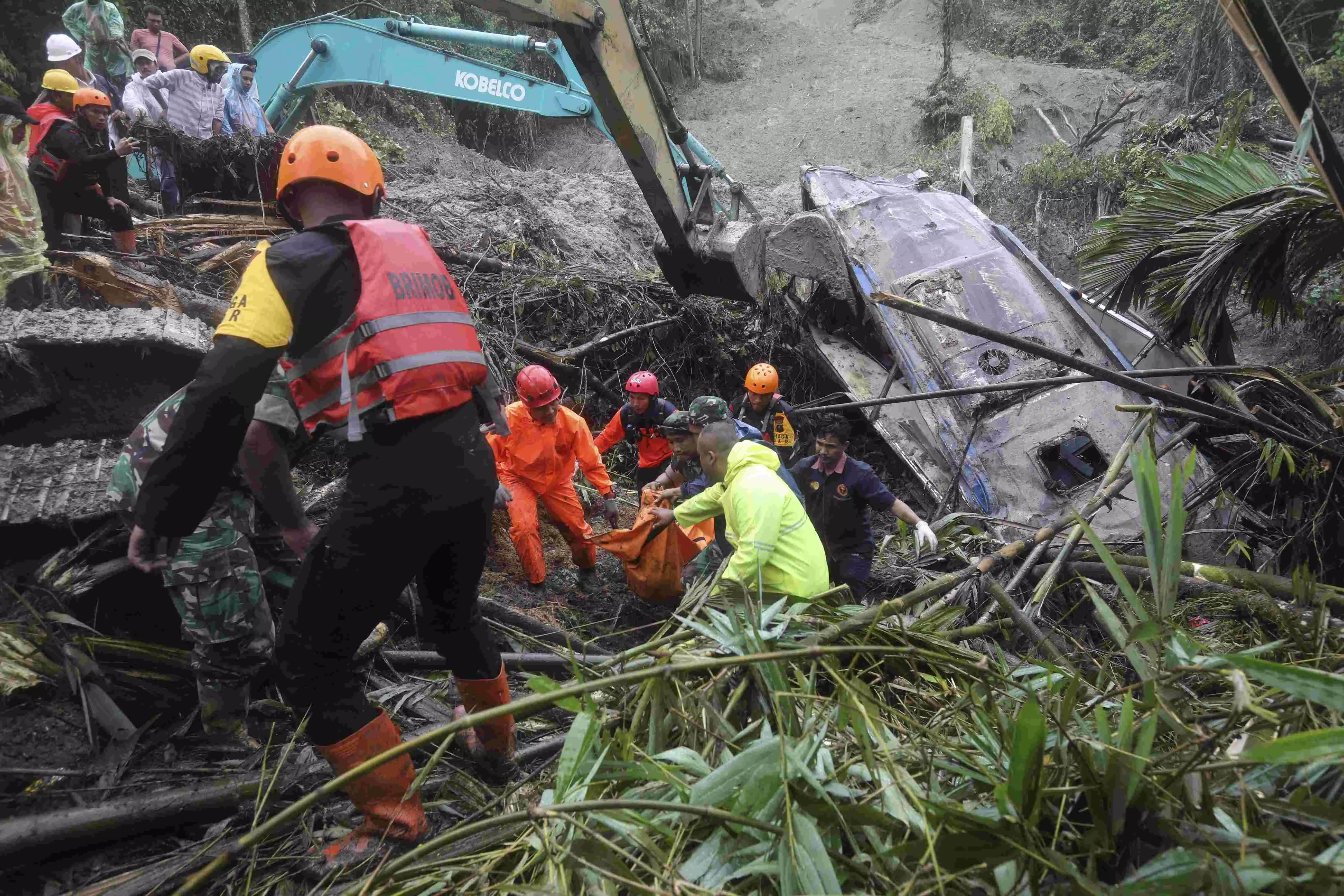 Landslide triggered by rain in Indonesias Sumatra island kills 9 people in tourist bus
