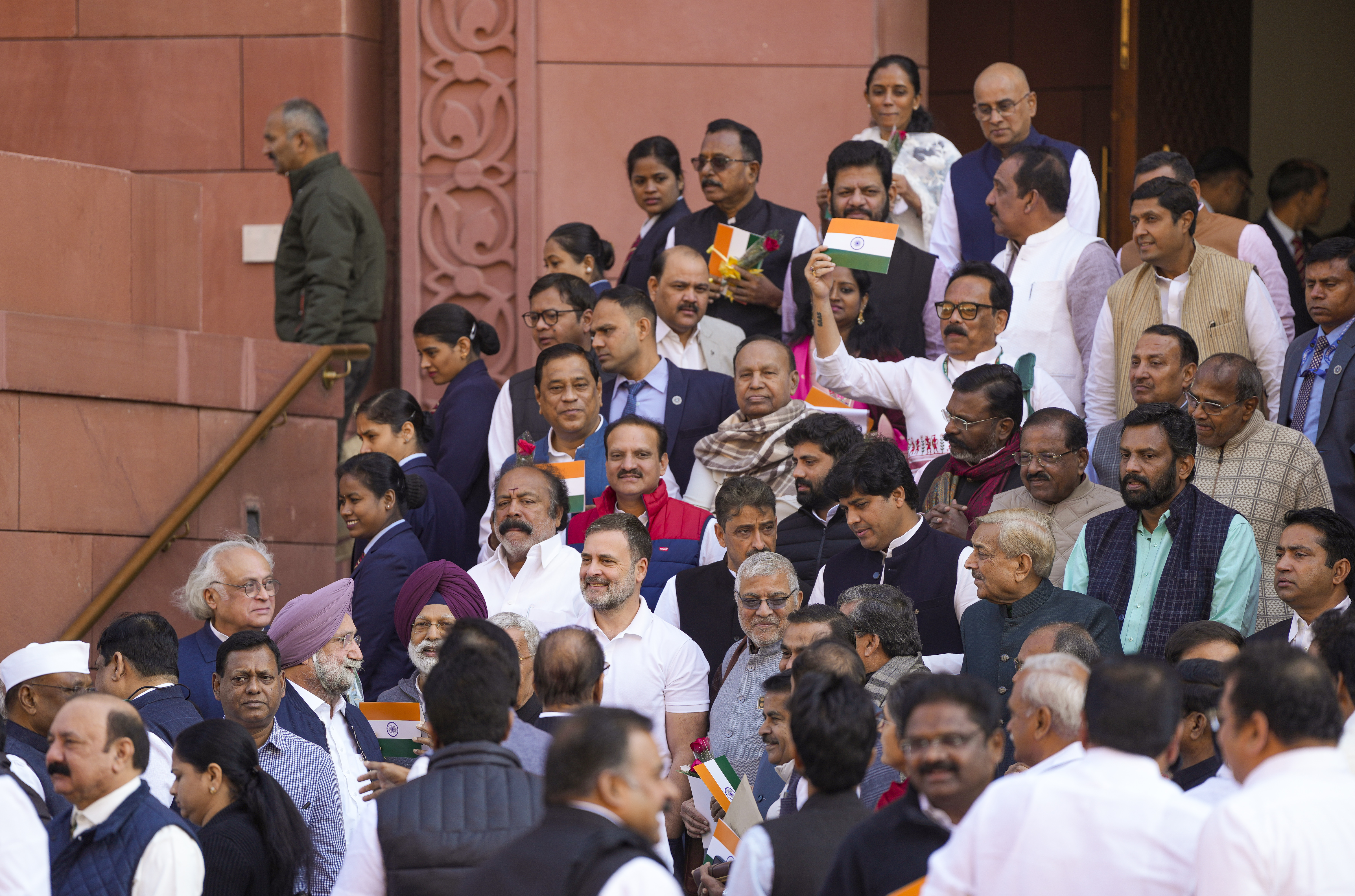 Small tricolour, red rose in hand, Opposition MPs urge govt to run House