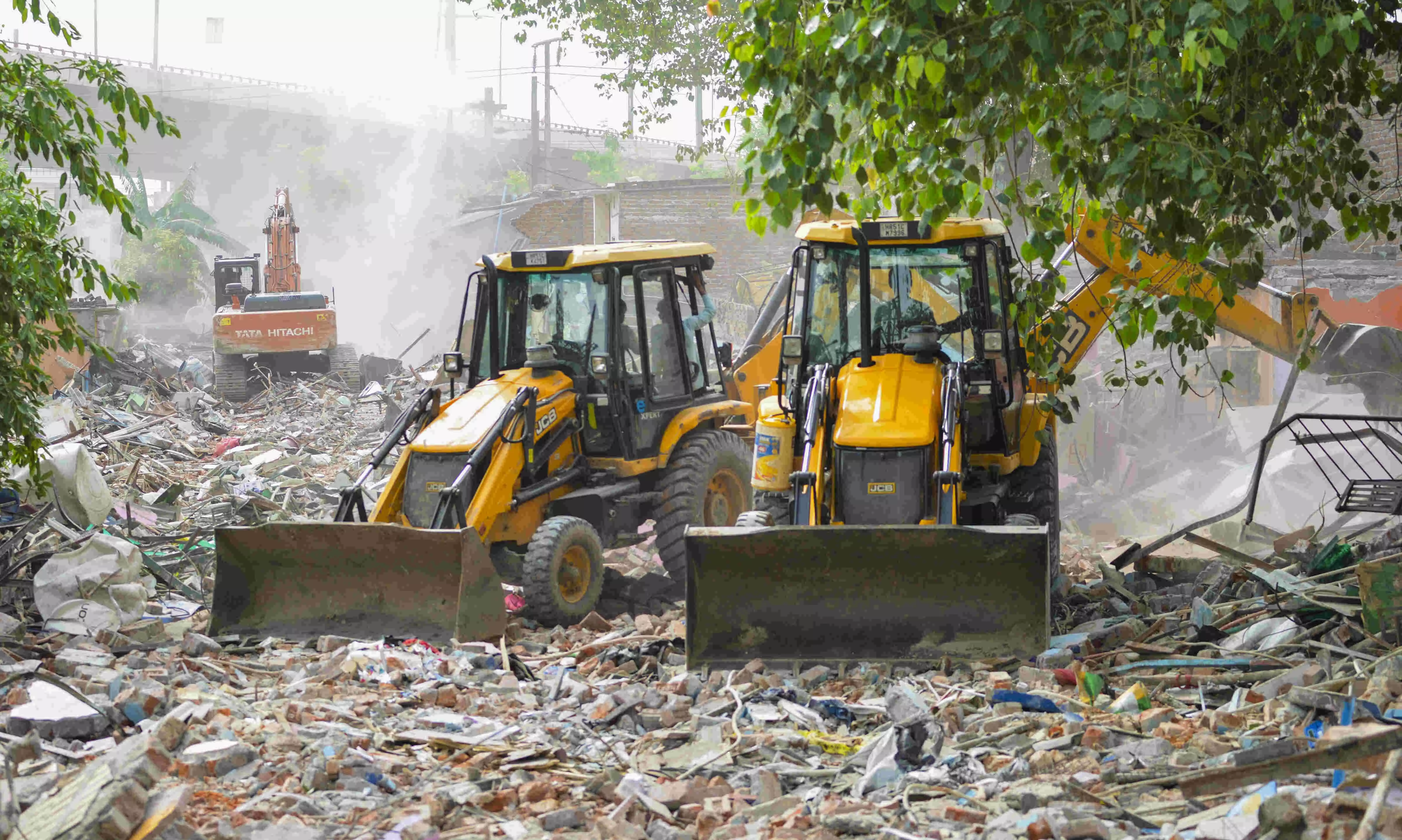 Residents watch their decades-old homes razed during demolition drive in Delhis Madrasi Camp
