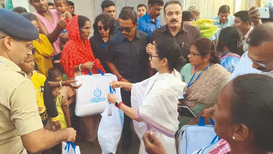 CM visits flood-hit tea garden, hands over relief materials to residents