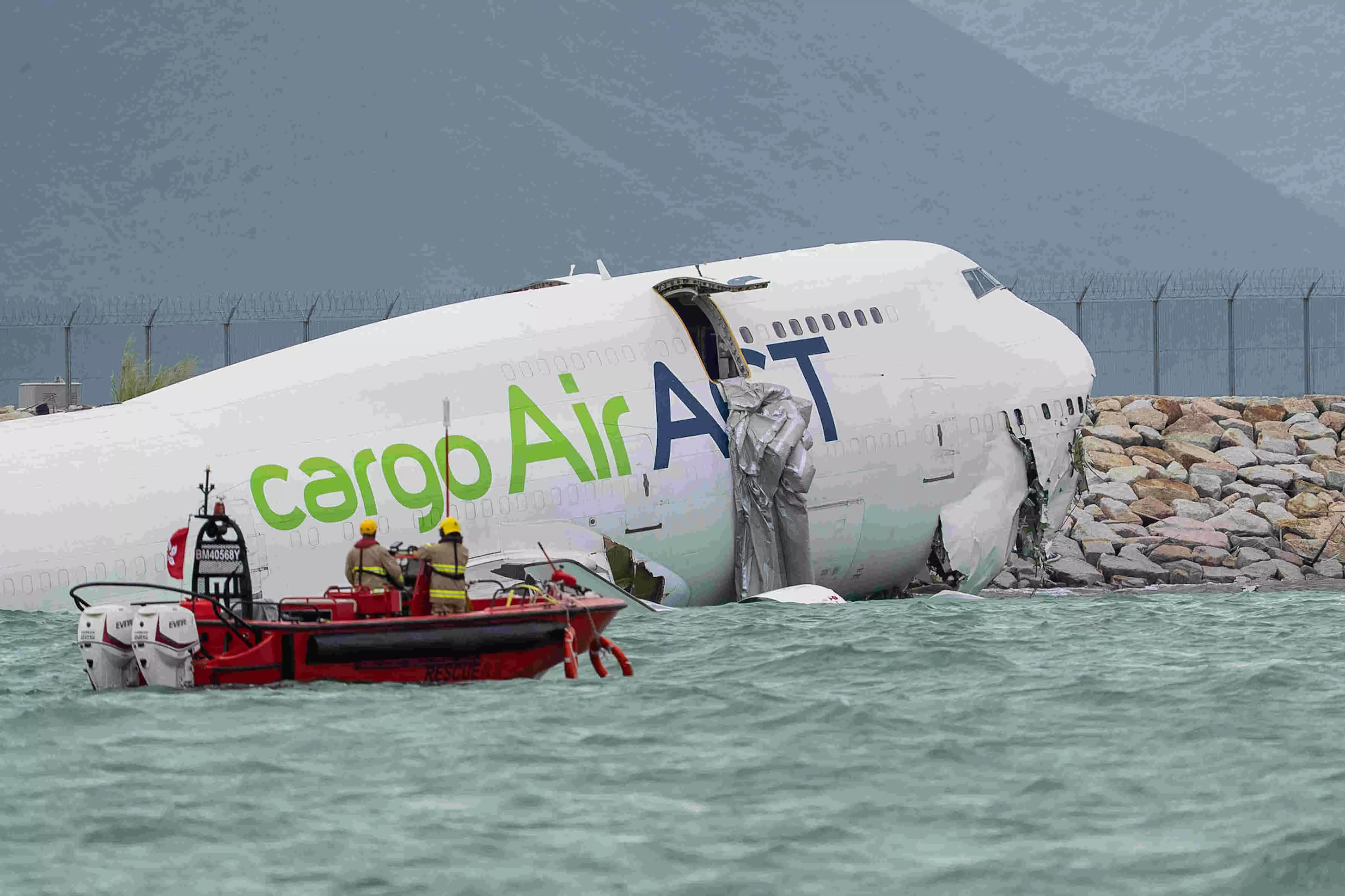 Two dead as cargo plane skids off runway and crashes into sea at Hong Kong airport Two dead as cargo plane skids off runway and crashes into sea at Hong Kong airport